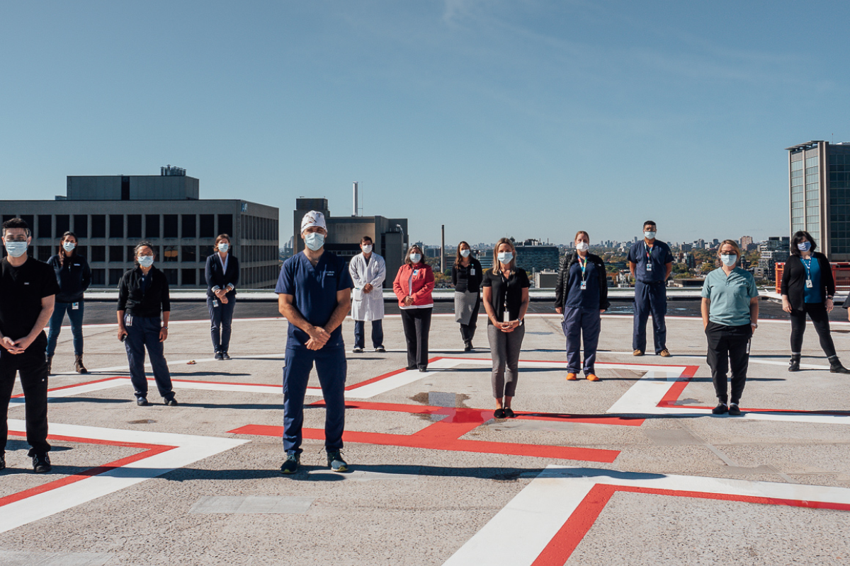 SickKids hospital workers standing on top of the emergency helicopter pad.